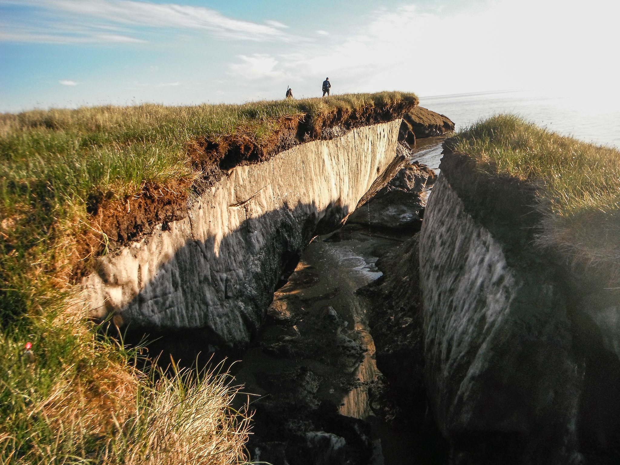 A chunk of permafrost underlain ground breaks off from the coast in Alaska.