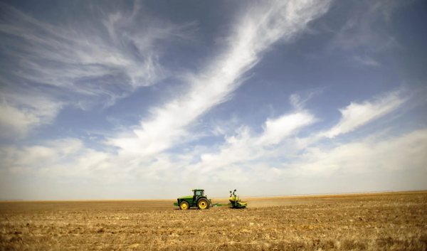 Beautiful blue sky with a tractor in a the background