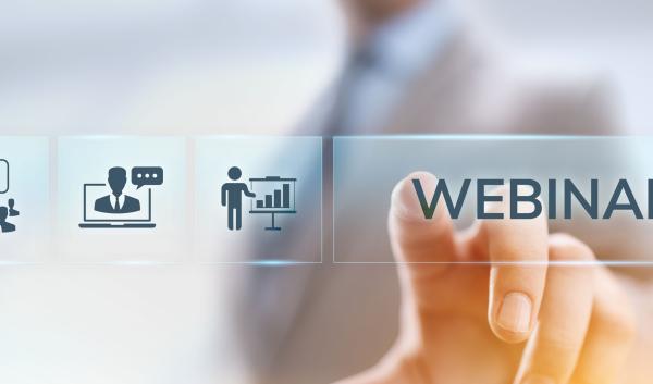 Photo of a person pressing a button that says "Webinar."